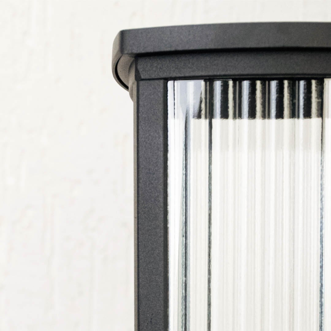 Black outdoor pillar light with frosted glass and strong base perfect for patio terrace garden and balcony lighting.