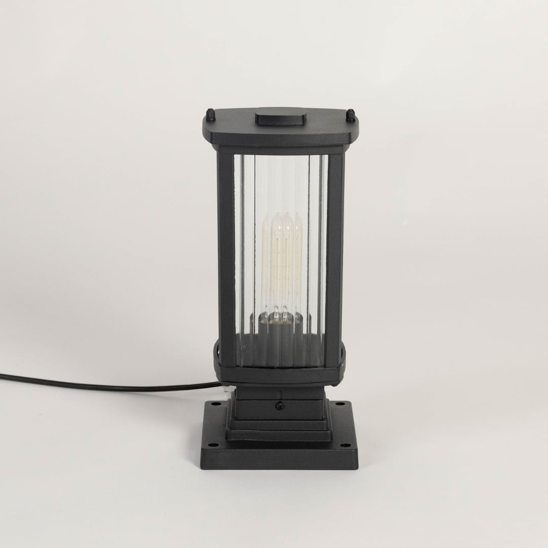 Black metal outdoor pillar lamp glowing LED through frosted glass ideal for patio balcony terrace and outdoor deco
