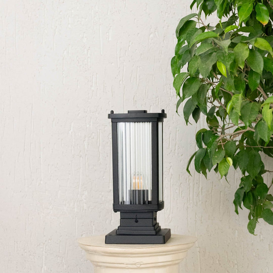 Pillar light shown on an off white background with a tall rectangular frame and clear glass panels displayed as a dimension image for size reference.