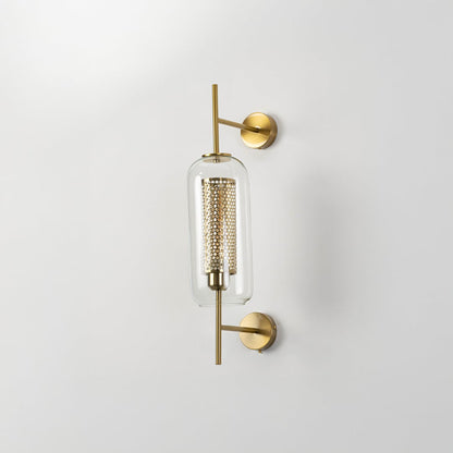 Contemporary wall lamp with gold finish and clear glass shade ideal for bedroom or living room wall decoration.