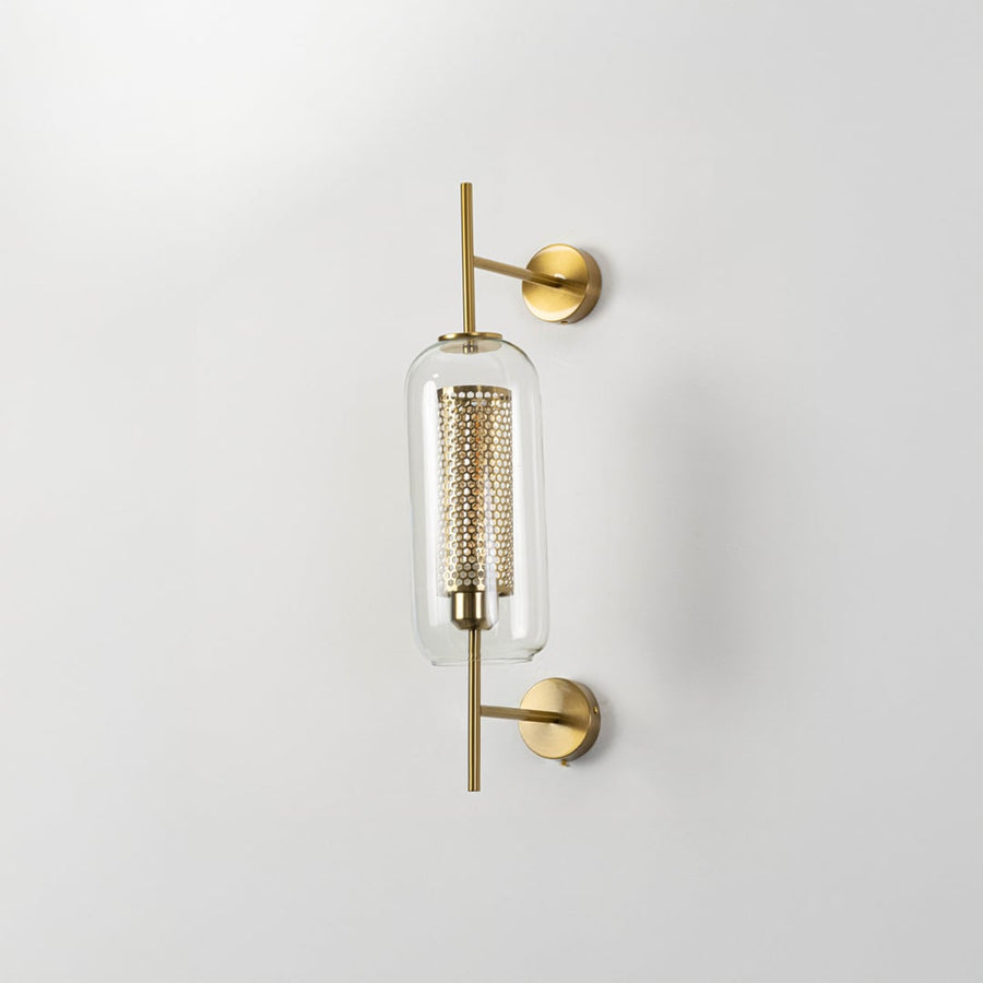Contemporary wall lamp with gold finish and clear glass shade ideal for bedroom or living room wall decoration.