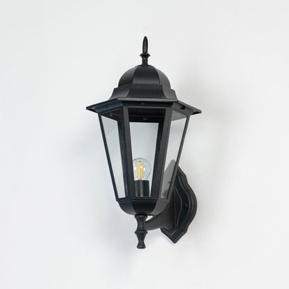 Classic black outdoor wall light displayed off against white backdrop highlighting tall lantern shape and durable build.