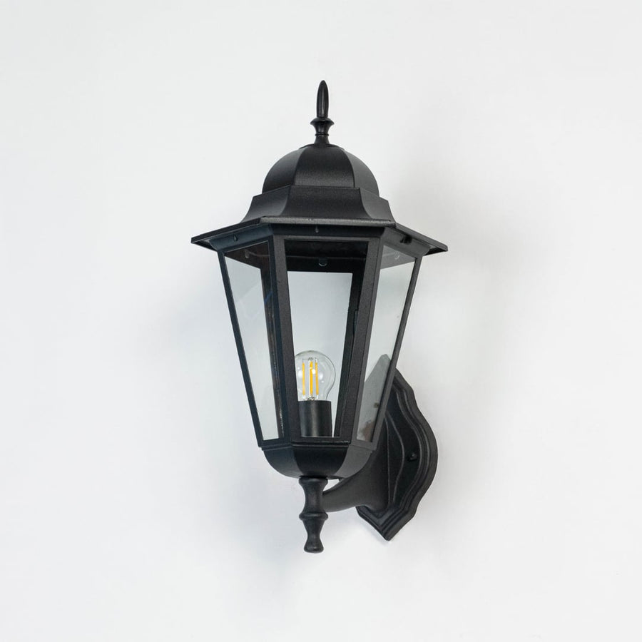 Classic black outdoor wall light displayed off against white backdrop highlighting tall lantern shape and durable build.