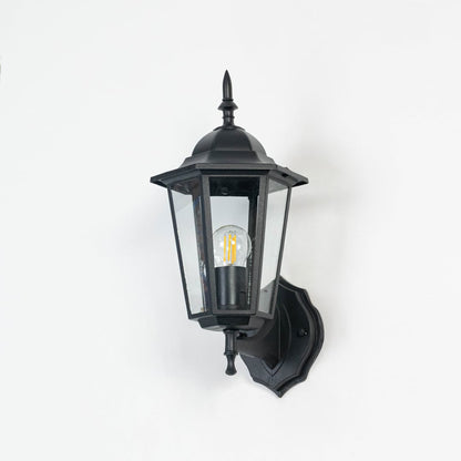Outdoor wall lantern in matte black finish shown off on white background with clear glass panes and clean detailing.