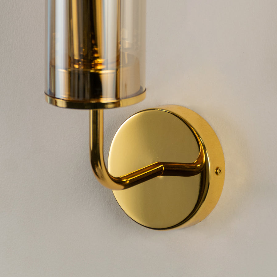 Elegant brass metal wall light fixture with polished finish for modern bedroom and hallway decor.