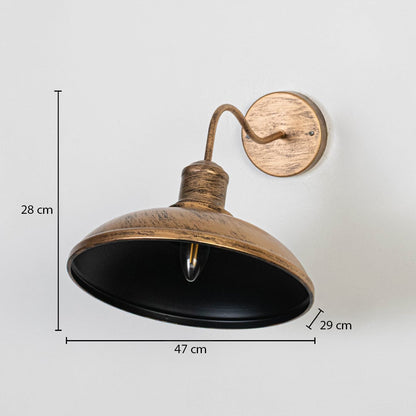 Outdoor wall light in antique metal finish with wide shade mounted on wall showing 28 cm height 47 cm width and 29 cm projection.