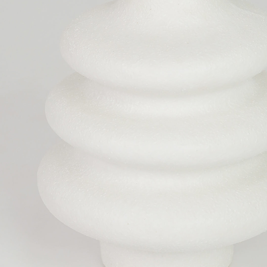 Closeup image of white ceramic ribbed vase for modern tabletop decor styling with elegant matte finish display.