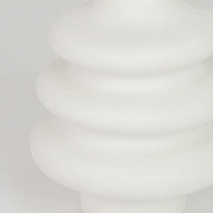 Closeup image of white ceramic ribbed vase for modern tabletop decor styling with elegant matte finish display.