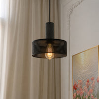 Black mesh pendant light with warm glow hanging beautifully in sophisticated home interiors.