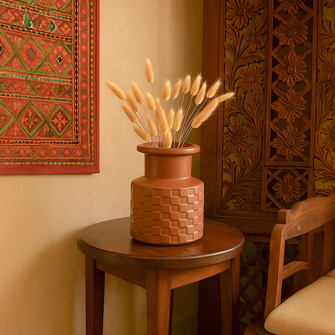 Terracotta brown ceramic vase with textured design styled on shelf adds warm earthy tone to modern home decor.