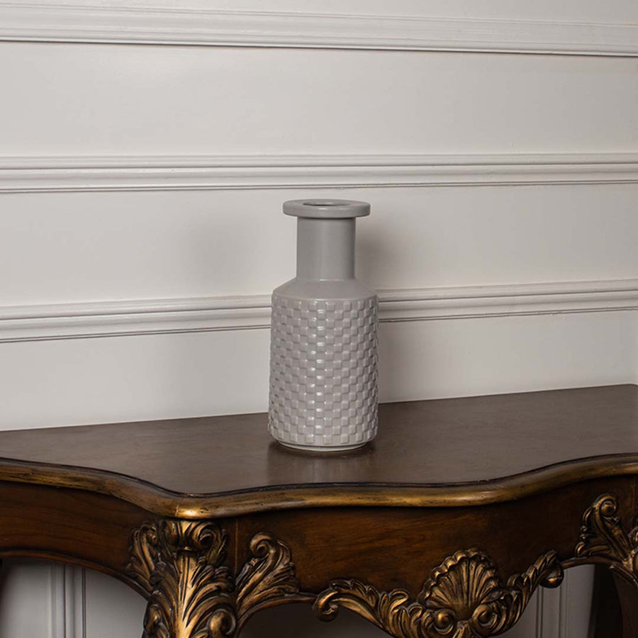 Modern light grey ceramic vase with embossed textured pattern shown on a plain white background perfect for elegant interior styling.