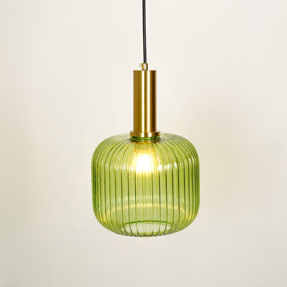 Green ribbed glass pendant light with brass finish illuminated on white background for modern kitchen and dining decor style.