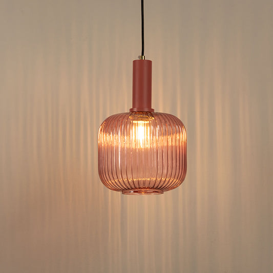 Textured glass pendant light with warm amber glow hanging from ceiling modern decorative lighting perfect for dining and living room decor.
