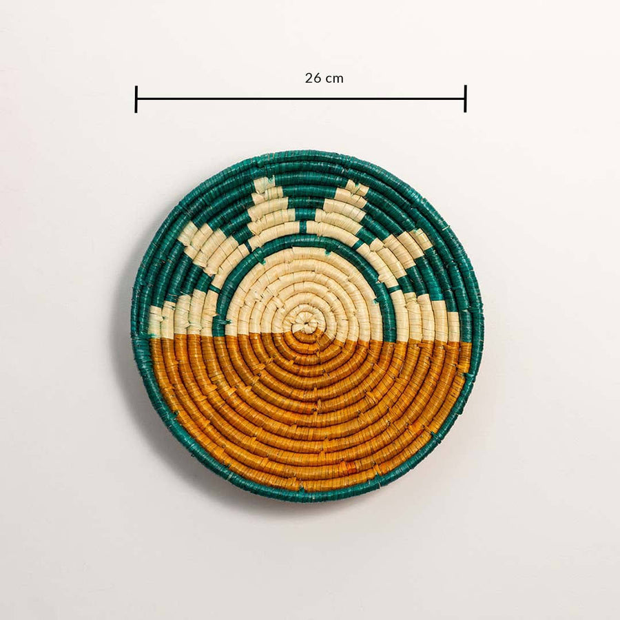 Dimension image of handcrafted teal and brown seagrass wall basket with sunrise pattern for boho living room décor display.