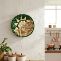Green and beige bamboo wall plates displayed above cream sofa adding rustic charm to modern minimalist living room.