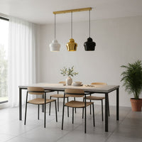 Mixed finish pendant lights creating warm ambience above the dining table in contemporary spaces.