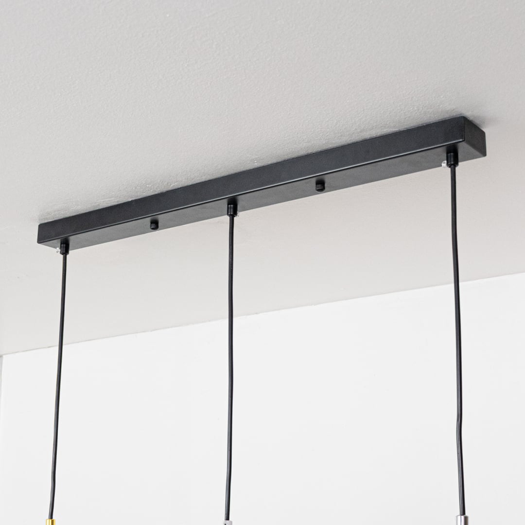 Closeup showing smooth metallic finish and dome shape of modern gold white and chrome hanging light.