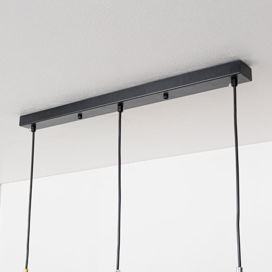 Closeup showing smooth metallic finish and dome shape of modern gold white and chrome hanging light.