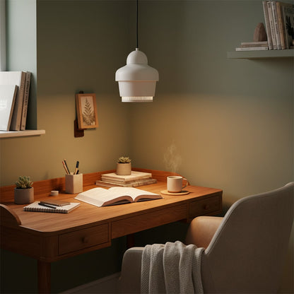 Pendant light with white glass shade hanging above wooden desk adding focused warm lighting and calm atmosphere to modern study room decor.