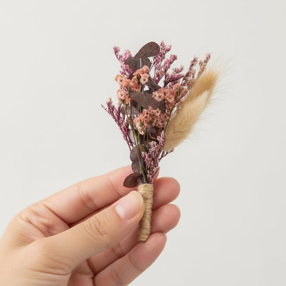 Handheld dried flower bouquet with earthy brown pink and beige preserved florals ideal for boho home decor and craft styling.