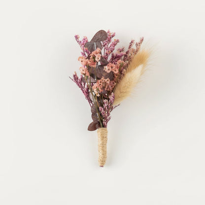Dried floral stem bouquet with pink blossoms beige pampas and muted foliage on white background highlighting soft textures handcrafted elegance and decor styling appeal.