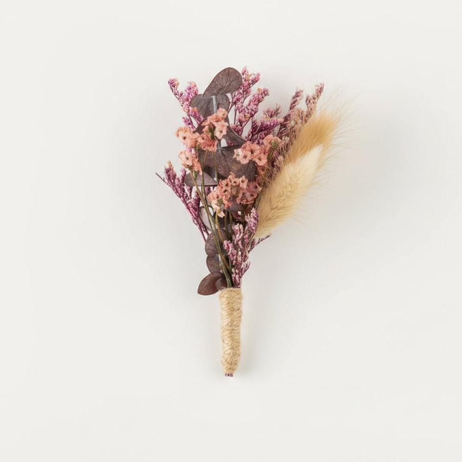 Dried floral stem bouquet with pink blossoms beige pampas and muted foliage on white background highlighting soft textures handcrafted elegance and decor styling appeal.