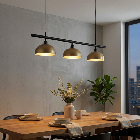 Black and gold metal linear pendant light creating warm ambience above the dining table in interiors.