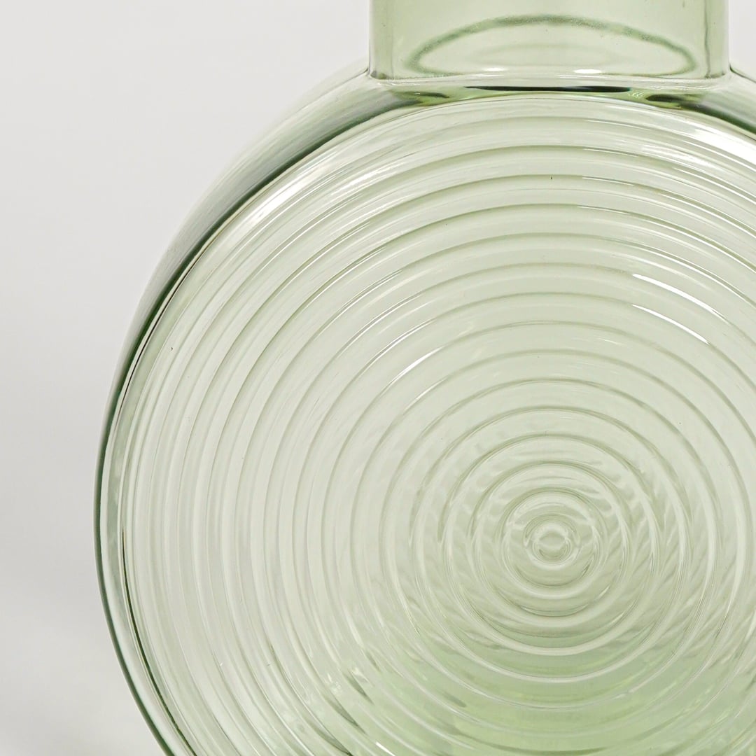 round geometric shape glass vase green closeup