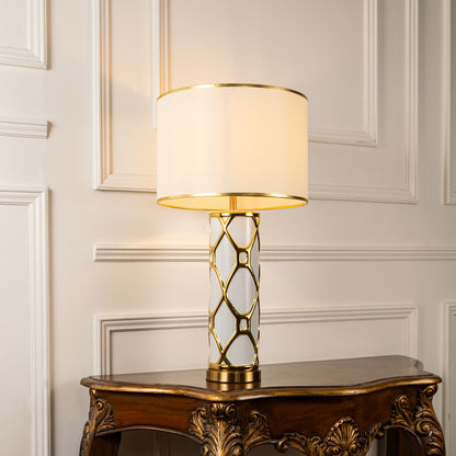 Gold lattice metal table lamp with fabric shade creating sophisticated decorative lighting for luxury interior spaces.