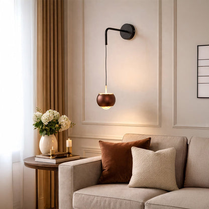 Elegant black and brass wall light enhancing cozy bedroom decor with warm ambient lighting.