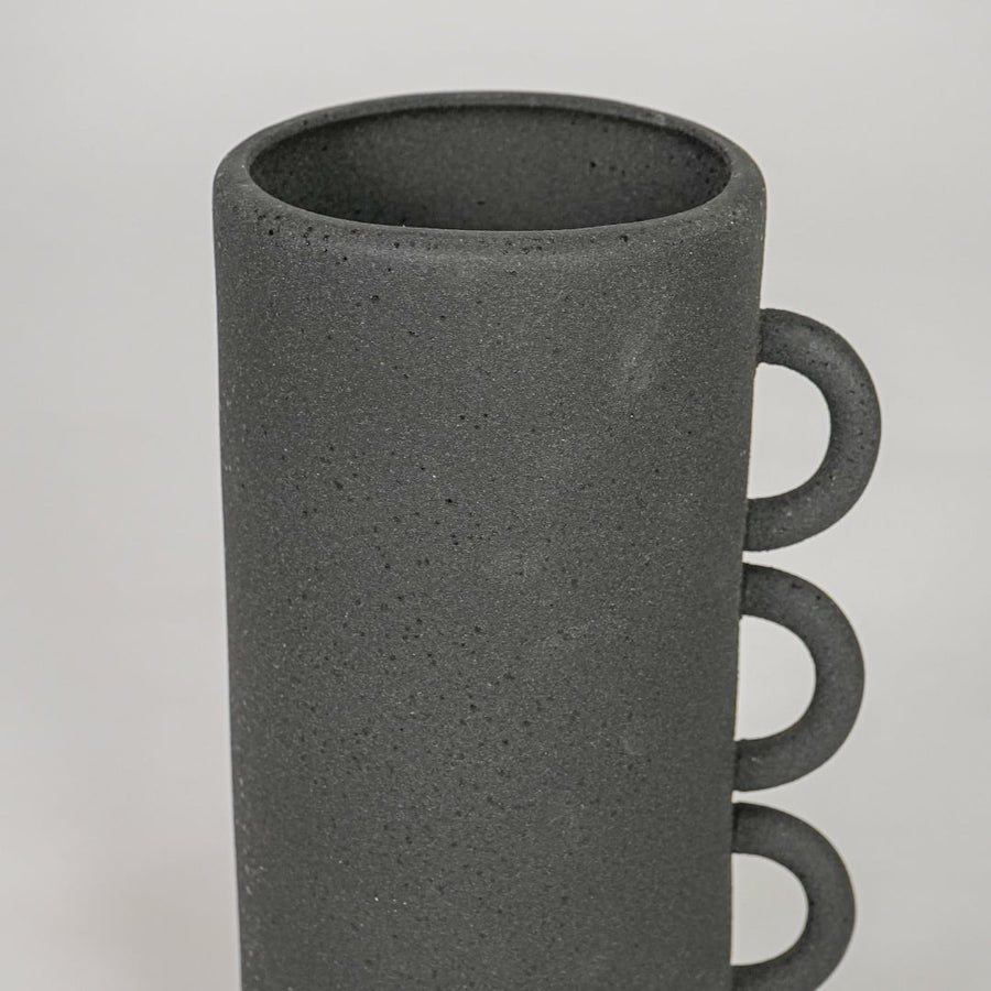 Closeup black ceramic textured decorative vase surface detail modern tall flower vase for table shelf console home decor styling.
