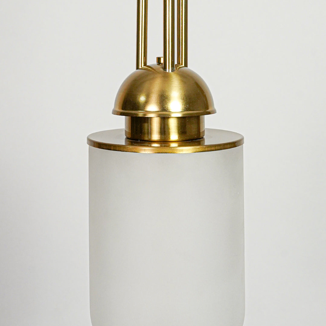 Closeup of white glass and gold metal pendant light highlighting smooth finish and refined craftsmanship.