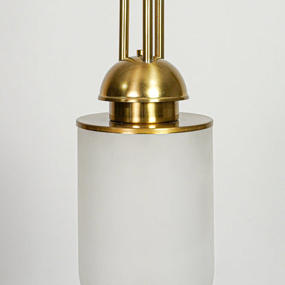 Closeup of white glass and gold metal pendant light highlighting smooth finish and refined craftsmanship.