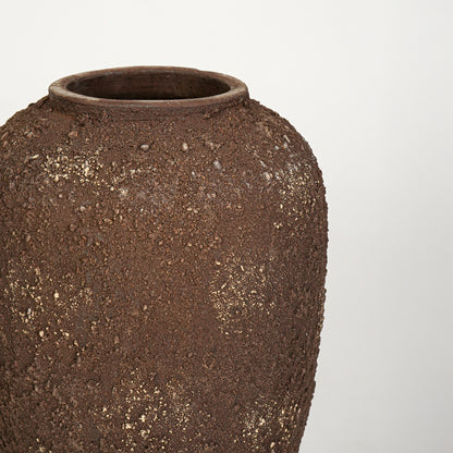 Closeup image of brown ceramic decorative vase for modern living room styling with textured rustic finish.