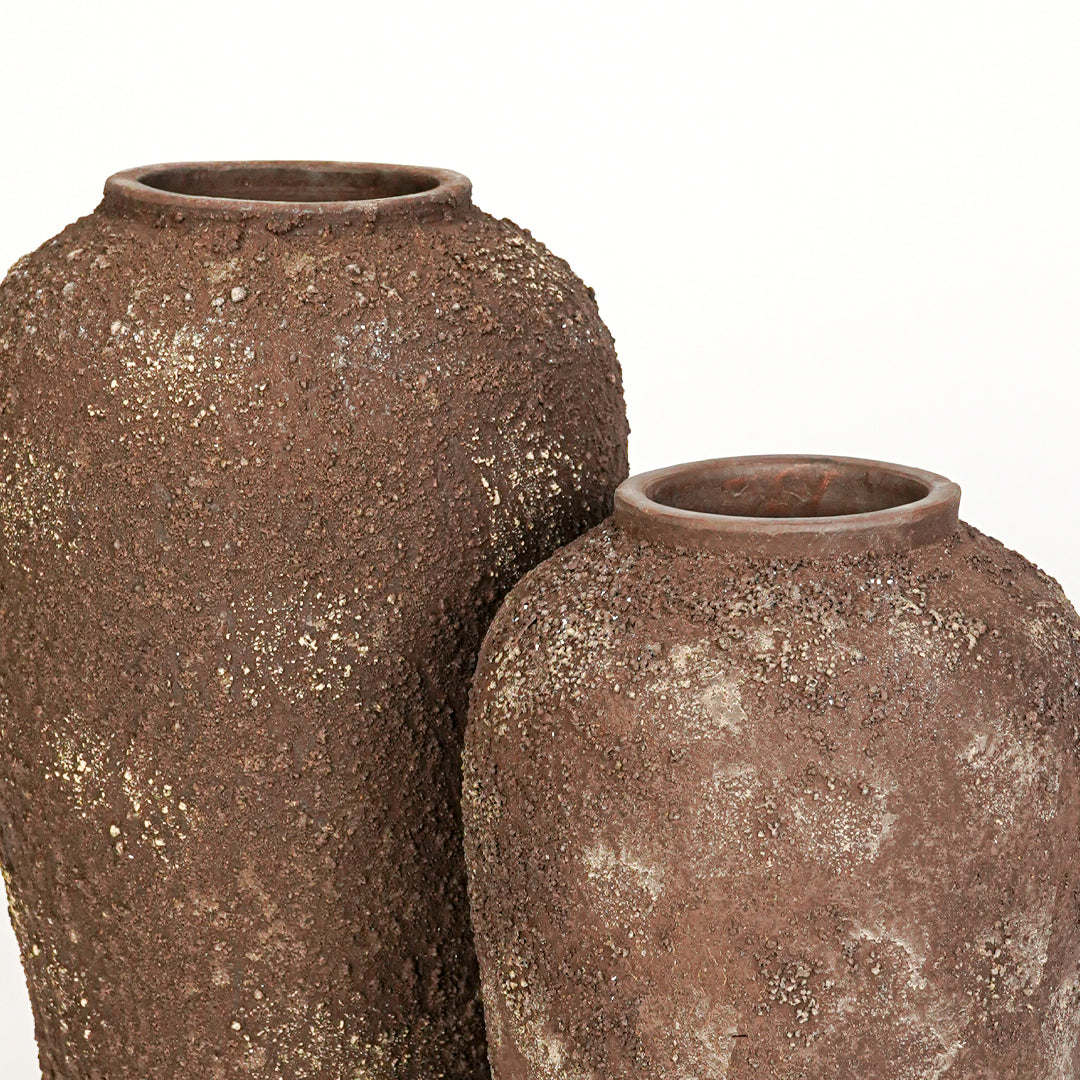 Closeup image of brown ceramic vase set for modern interior decor styling with rustic textured finish.