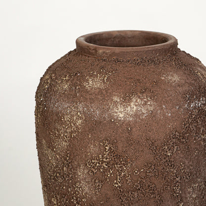 Closeup image of brown ceramic rustic vase for modern floor decor styling with textured artistic finish.