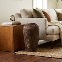 Lifestyle image of brown ceramic floor vase for modern living room decor styling with rustic textured finish.