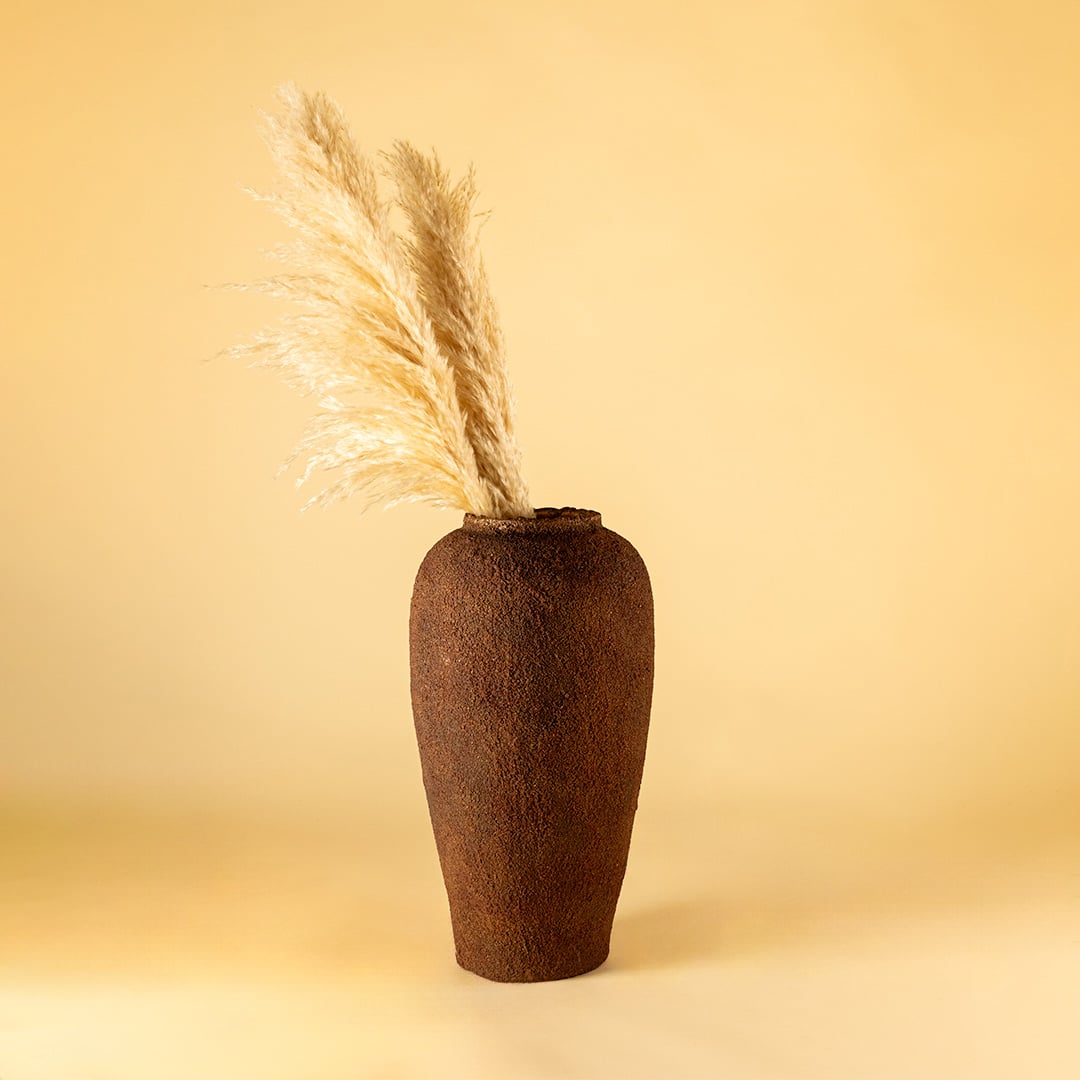 Brown ceramic floor vase with textured rustic finish styled with dried pampas grass for elegant home decor.