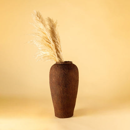 Brown ceramic floor vase with textured rustic finish styled with dried pampas grass for elegant home decor.