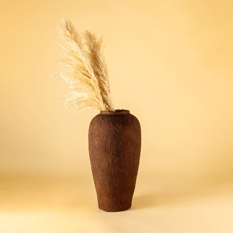 Brown ceramic floor vase with textured rustic finish styled with dried pampas grass for elegant home decor.