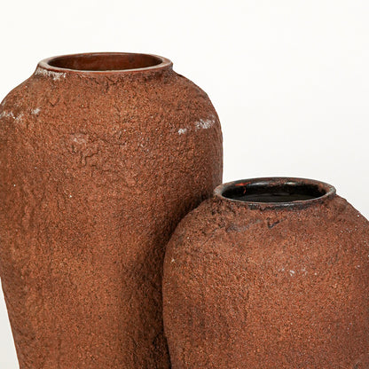 Closeup image of terracotta ceramic vase set for modern interior decor styling with rustic textured finish.