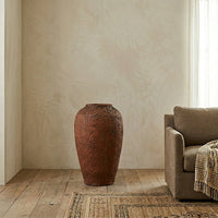 Brown textured ceramic floor vase placed in corner for stylish contemporary home decor styling.