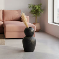 Black textured ceramic vase lifestyle image with pampas grass for elegant modern living room decor.