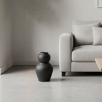 Black textured decorative vase arranged in a designed home setting adding sculptural artistic decor to living rooms entryways and reading corners.