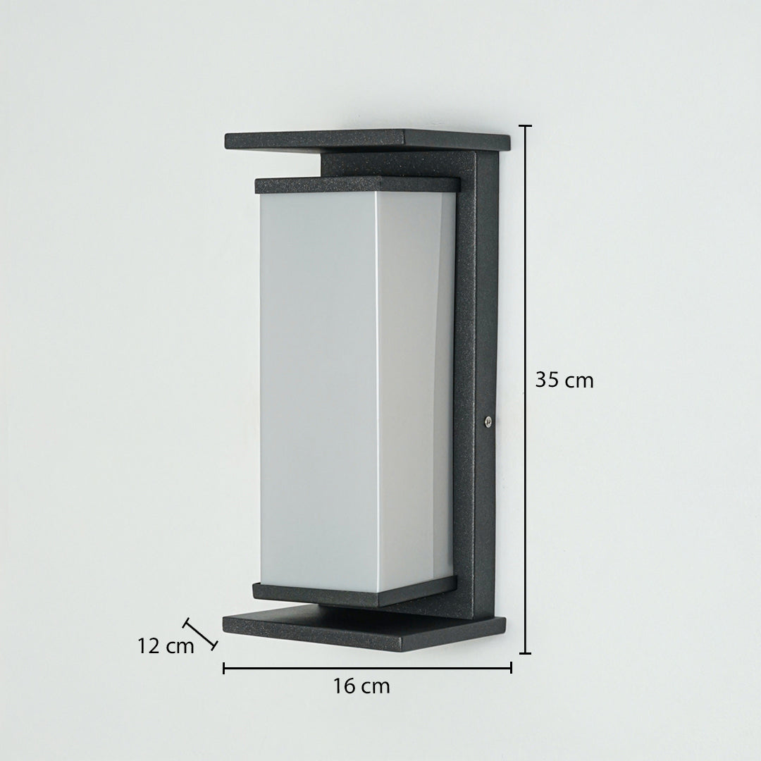 Modern outdoor wall light with rectangular frosted diffuser and black metal frame mounted on wall 35 cm height 16 cm width 12 cm depth ideal for exterior lighting.