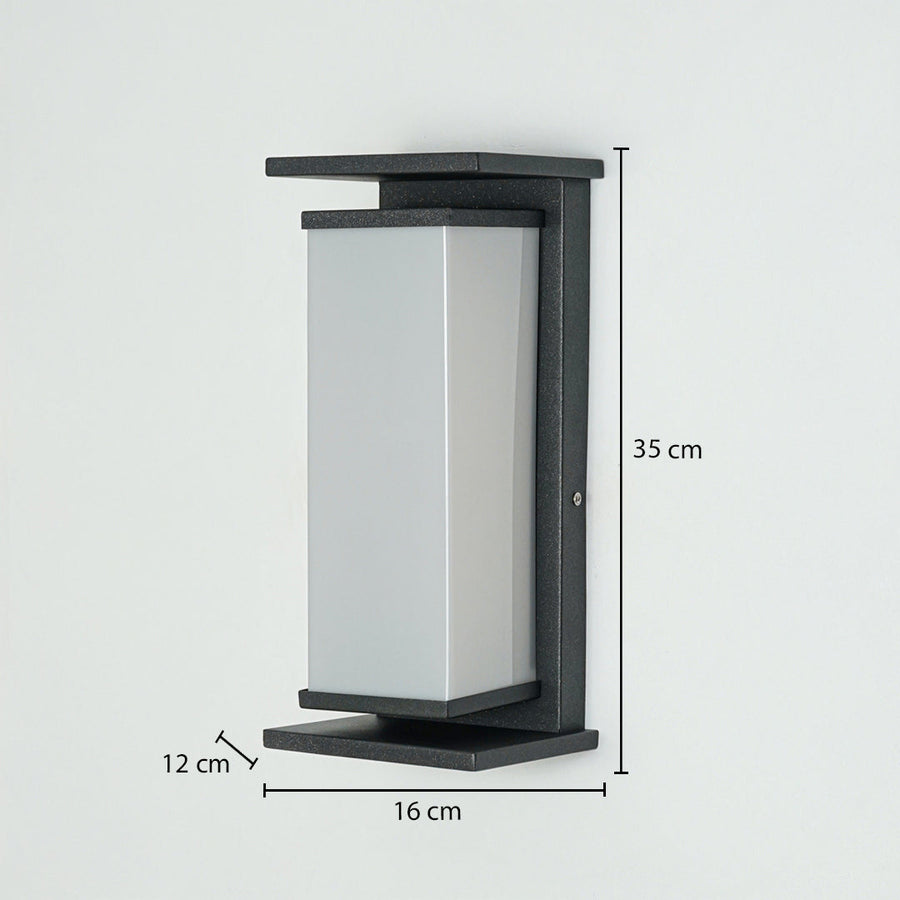 Modern outdoor wall light with rectangular frosted diffuser and black metal frame mounted on wall 35 cm height 16 cm width 12 cm depth ideal for exterior lighting.