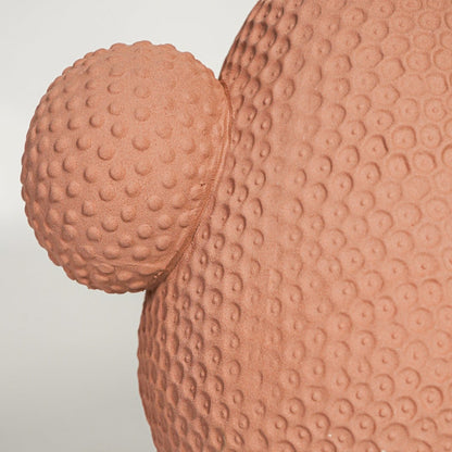 Close view of white marble ceramic vase showing smooth curved body polished finish and natural grey veining texture.