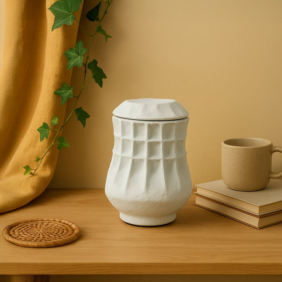 White ceramic decorative vase styled on a wooden table for elegant contemporary home decor and tabletop styling.