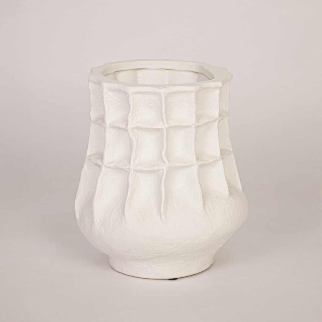 Modern white ceramic flower vase with sculpted pattern isolated on white background for product showcase.