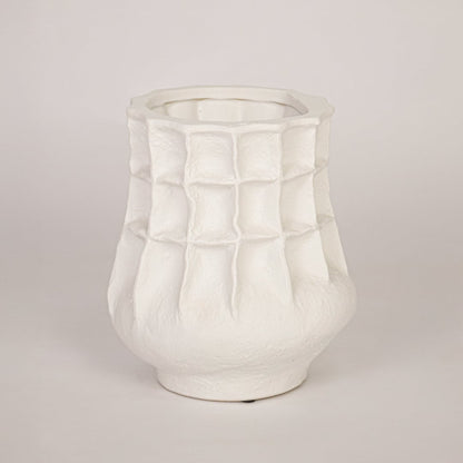 Modern white ceramic flower vase with sculpted pattern isolated on white background for product showcase.